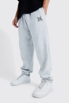 Man Overlap Embroidered Oversized Joggers | boohooMAN UK